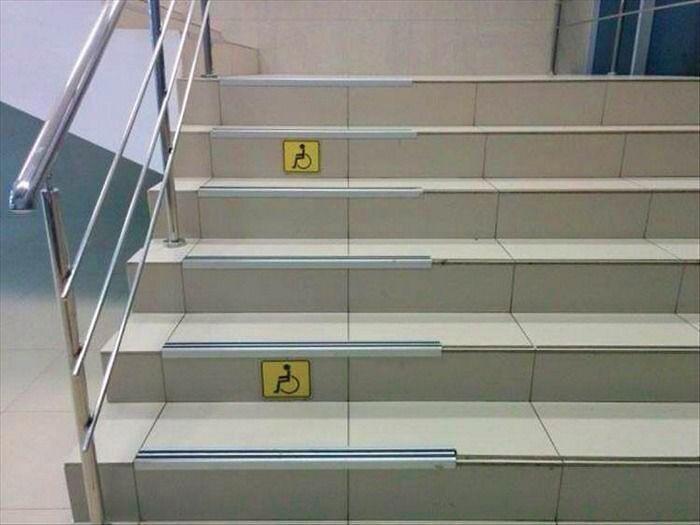 Stairs with wheelchair symbols, showcasing a city planning oversight.