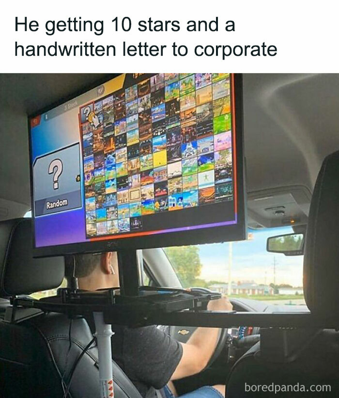Man driving with a game screen mounted in the car, featuring a meme about men and a humorous text overlay.