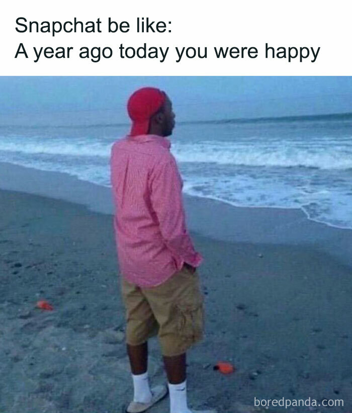 Man on beach with text overlay: "Snapchat be like: A year ago today you were happy." Humorous meme about men reflecting.