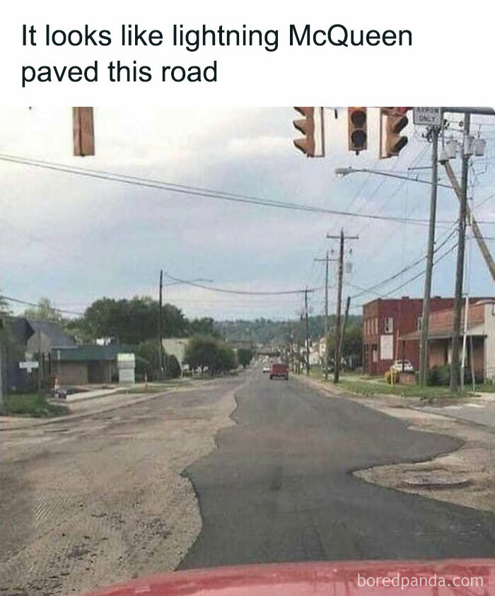 Bumpy road resembling Lightning McQueen's haphazard paving, with traffic light and street view, humor about men.
