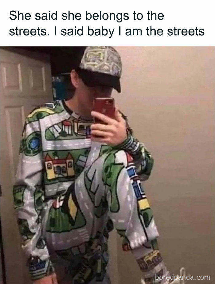 Man in a colorful street-patterned outfit takes a mirror selfie, humorously embodying the phrase "I am the streets."