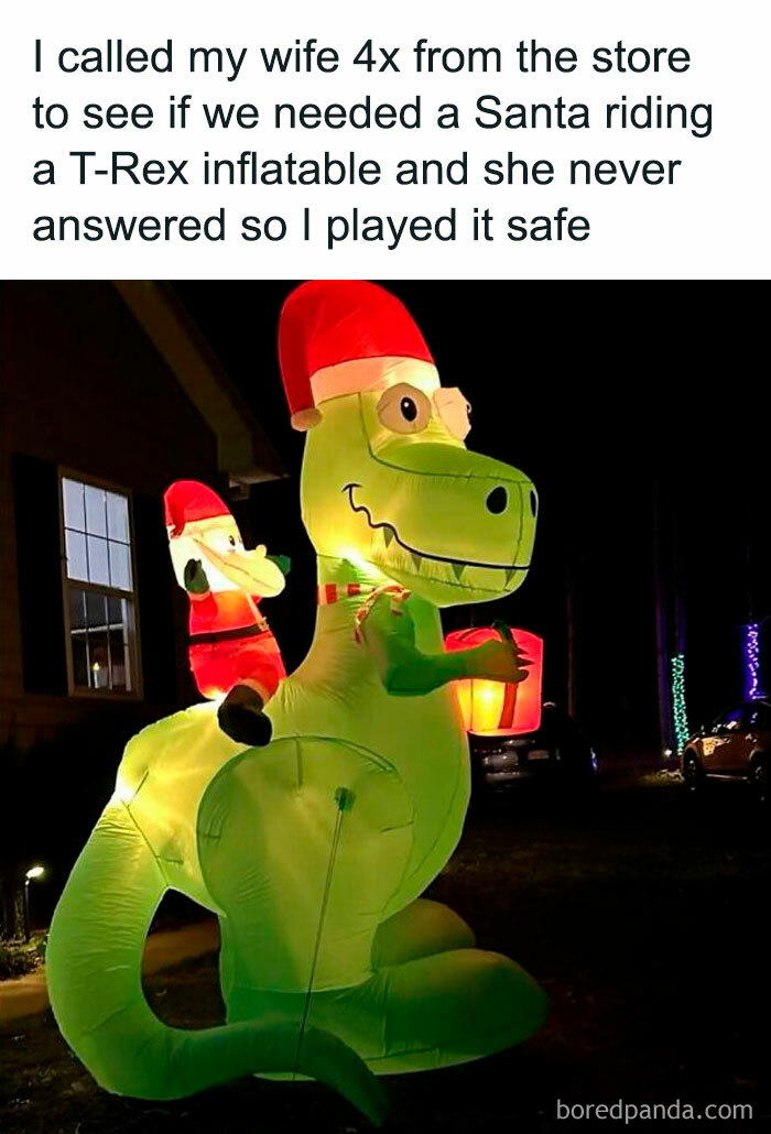Inflatable Santa riding T-Rex, showcasing dad humor with a holiday twist outside a house at night.