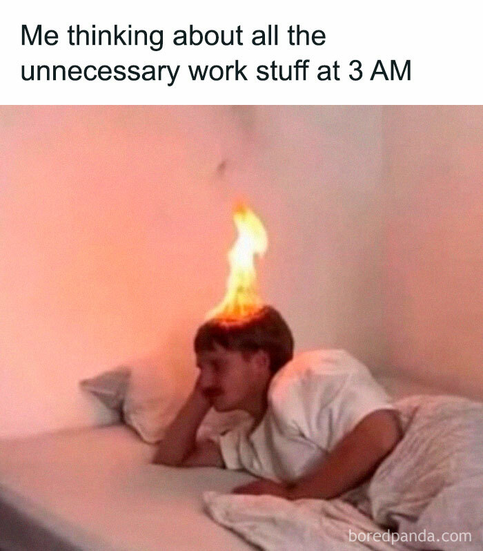 Man lying in bed with fiery hair, humorously illustrating relatable work stress at night.