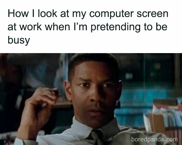 Person staring intently at a computer, humorously pretending to be busy, capturing a relatable work meme moment.
