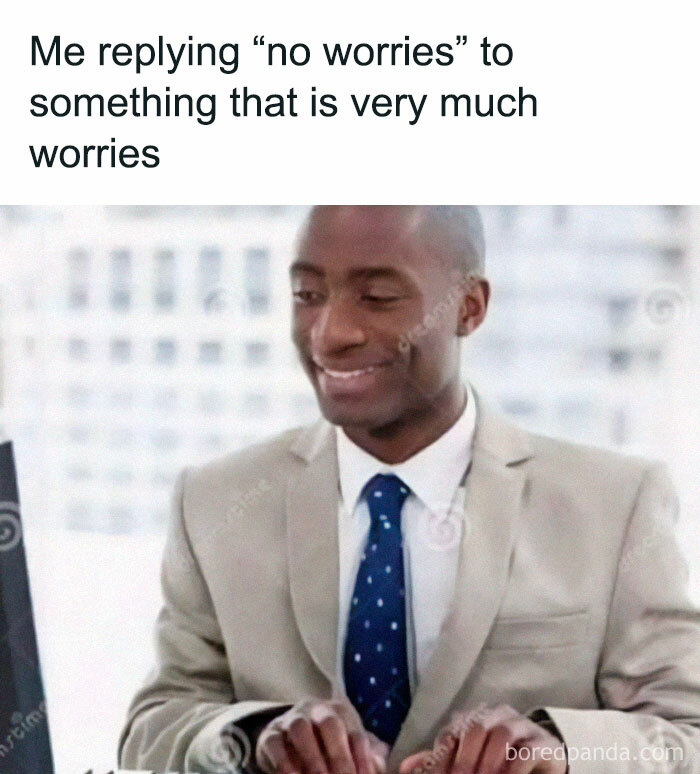 Man in suit smiling at computer, captioned with a funny relatable meme about work worries.