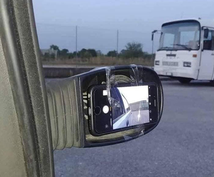 Side mirror repair fail using a phone camera taped in place.