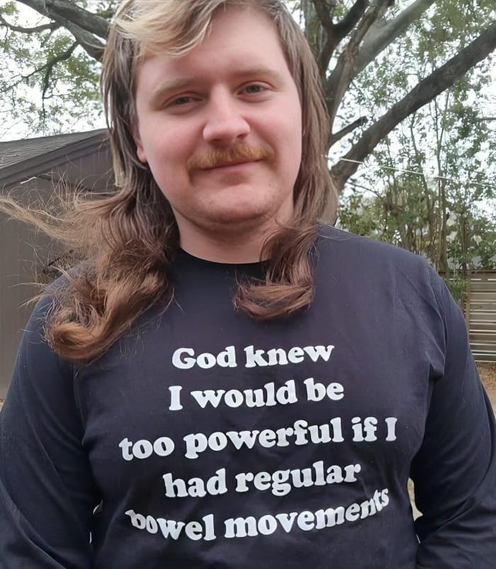 Hombre con camiseta negra divertida con texto humorístico, ejemplificando camisetas tan divertidas como ridículas para usar en público.