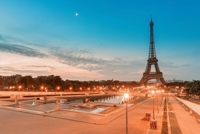 Eiffel Tower in Paris at sunset, highlighting tourist areas that aren't as cool to live in as they seem.