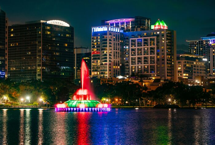 Night view of Orlando cityscape with colorful fountain, a top US travel destination this summer.