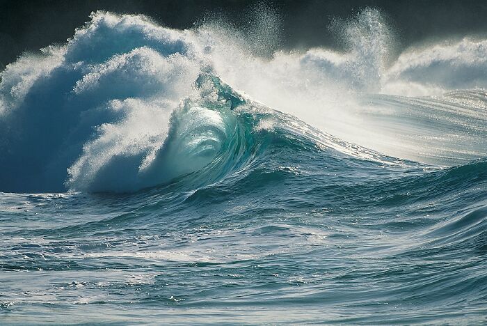 Powerful ocean waves crashing, evoking a sense of potential danger and instinctive caution.