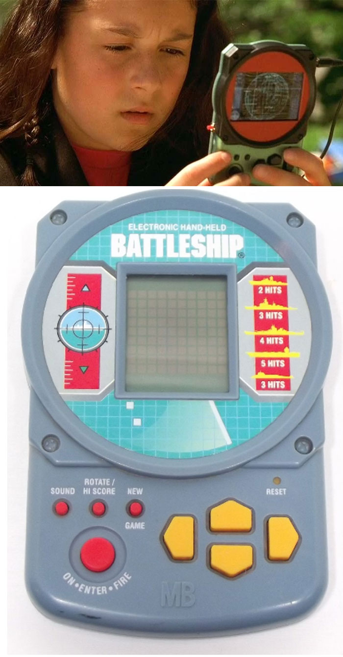 Actress holding a creative prop resembling an electronic handheld Battleship game.