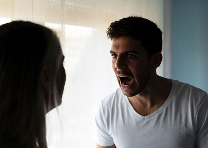 Man in a white shirt arguing with a person, highlighting a discovery that changed their relationship.