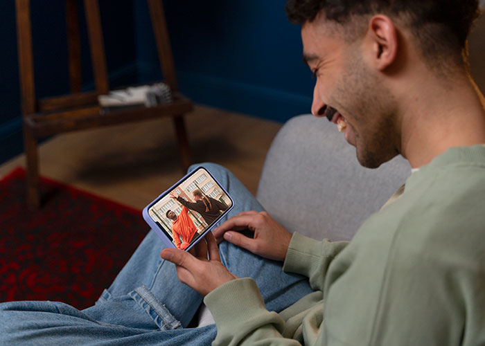 Man smiling at his phone screen, revealing unexpected content, reflecting on relationship insights.