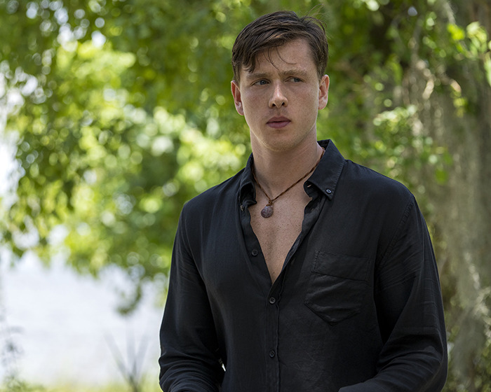 Young man in a black shirt outdoors, amid casting discussions for the Beatles biopic.