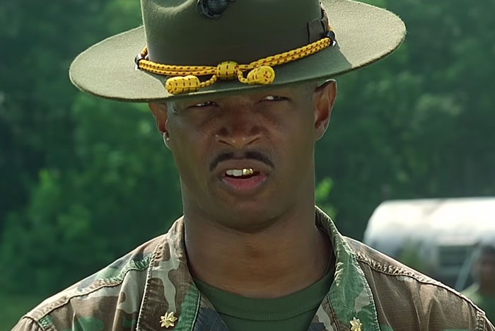 A film legend in a military outfit, possibly portraying a character on set.