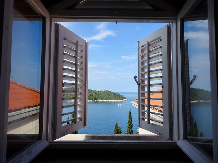Open window view of the sea and landscape, ideal inspiration for homeowner first home tips.