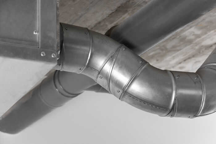 Metal ductwork in a home, illustrating a key consideration for homeowner-first-home-tips related to ventilation systems.