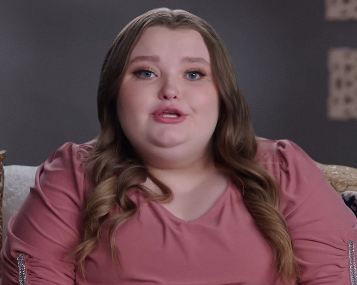 Young woman speaking on TV, wearing a pink top, discussing her turbulent life since 'Toddlers & Tiaras'.