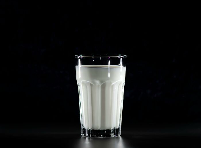 Glass of milk on a dark background, illustrating unpopular opinions.