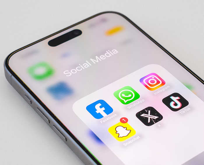 Smartphone displaying social media apps, representing online exposure of a cheating partner.