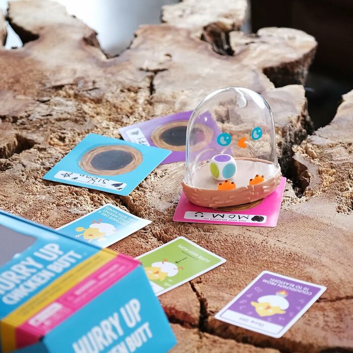 Colorful game pieces and cards on a wooden table, perfect items to unleash your inner child joy.