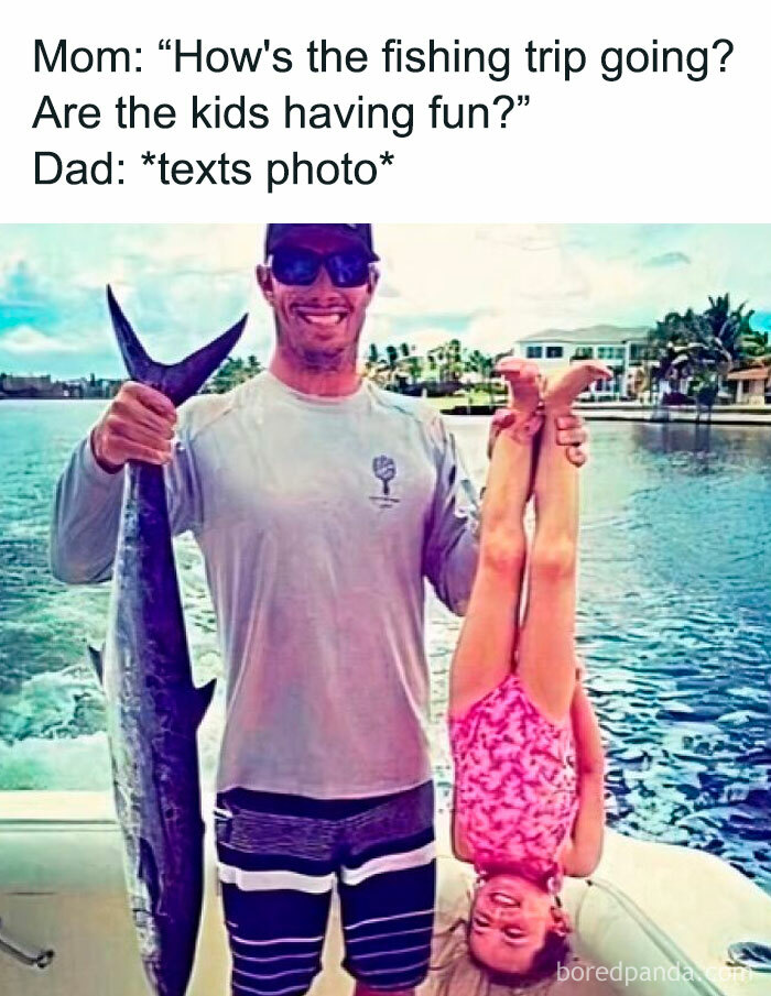 Man holding fish and child upside down on a boat, showcasing humor and sarcasm about a fishing trip.