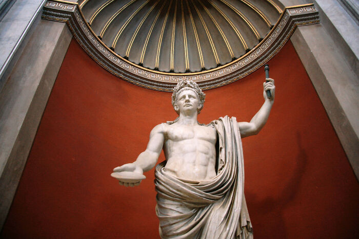 Classical statue of a man holding a scepter, symbolizing differences between men and women.
