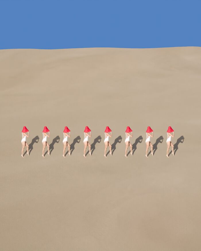 Nine people in red hats standing in line on sand, showcasing conceptual aerial photography.