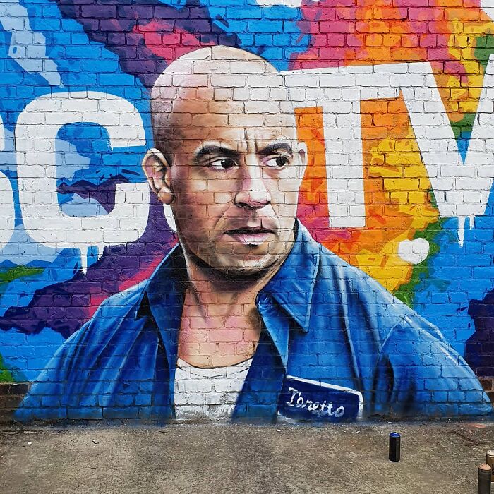 Mural featuring a vivid portrait on a colorful wall in Glasgow.