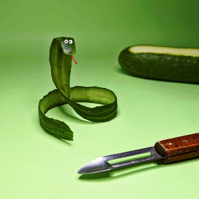 Cucumber peel styled as a playful snake illustration, with a peeler and cucumber in the background.