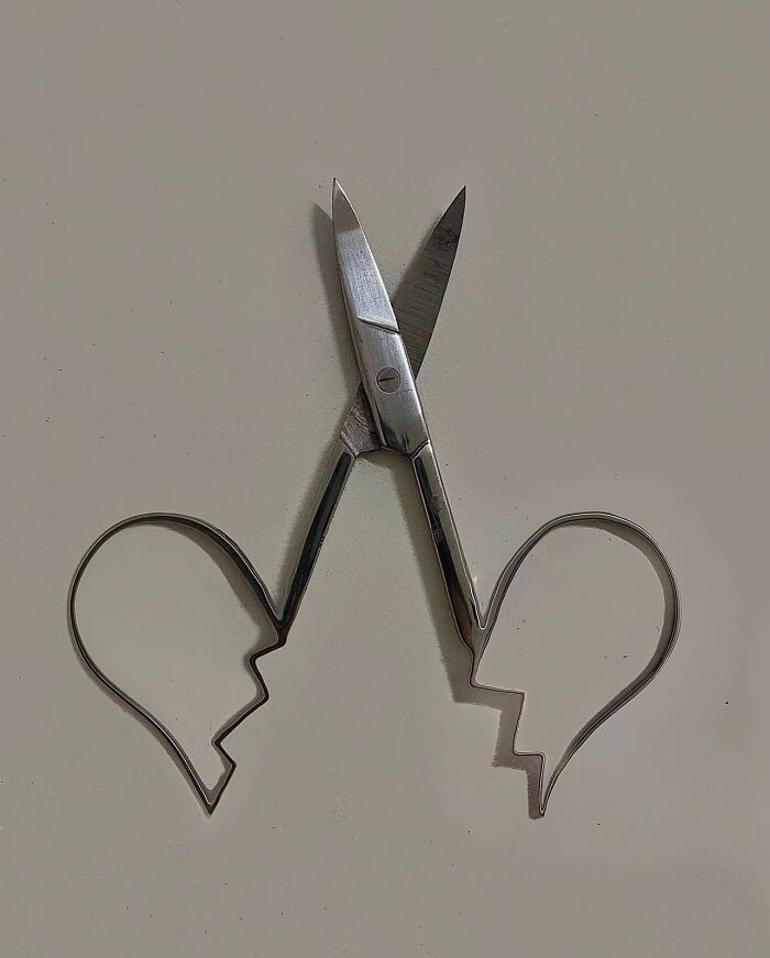Scissors transformed into thought-provoking artwork with heart-shaped handles.