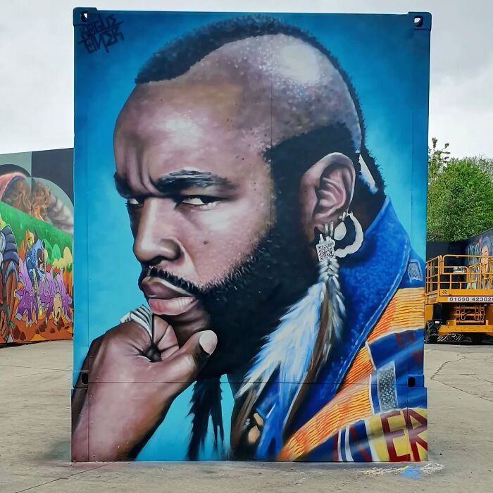 A vibrant mural in Glasgow featuring a man deep in thought, set against a blue background.
