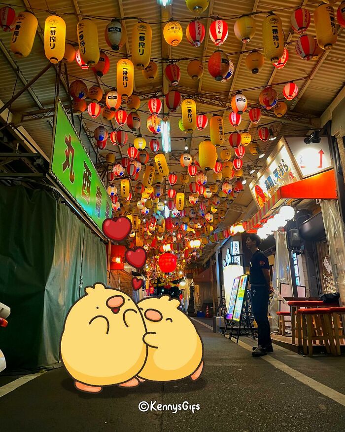 Cute animated birds hug under colorful lanterns in a vibrant street setting by Kenny Mays.