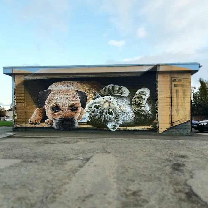Mural of a dog and cat on a Glasgow wall, showcasing captivating street art.
