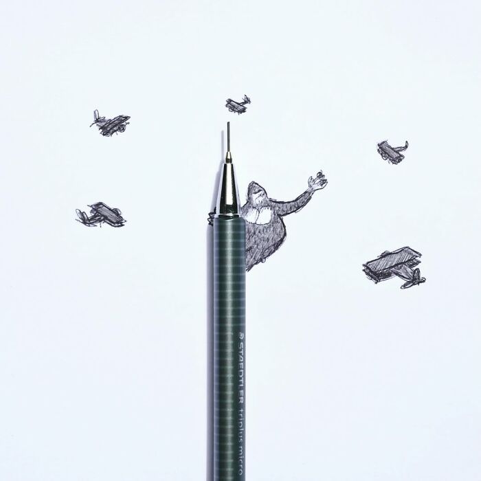 Playful illustration merging pen with drawing of King Kong and planes by Romain Joly.