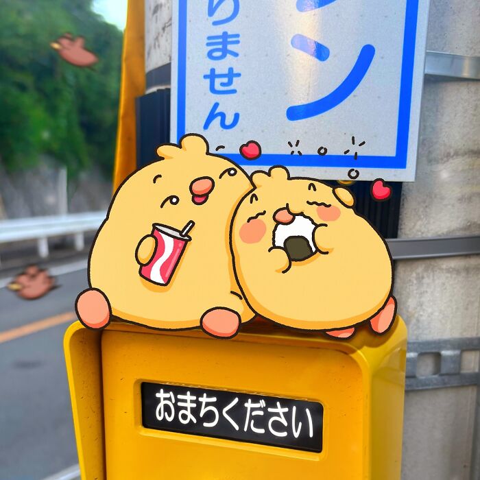 Cartoon birds Birb and Bread on a street sign, with one sipping a drink and the other eating a snack.