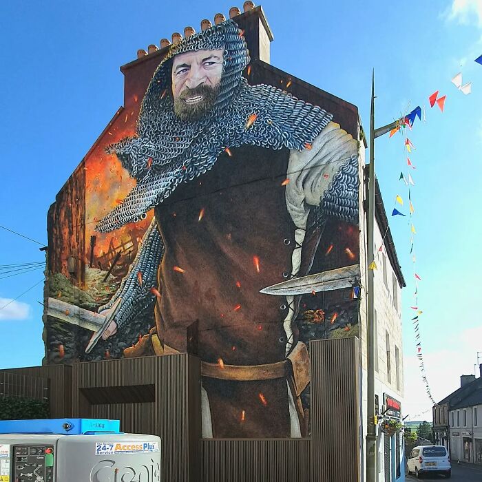 A captivating mural of a historic warrior adorns a wall in Glasgow.