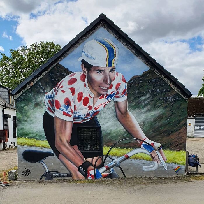 Cyclist mural painted on a Glasgow wall, capturing vibrant and dynamic street art.