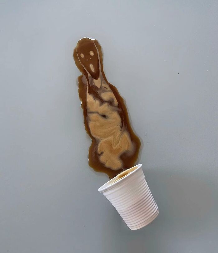 Spilled coffee cup forming a ghostly art shape, showcasing transformation of common items into art.