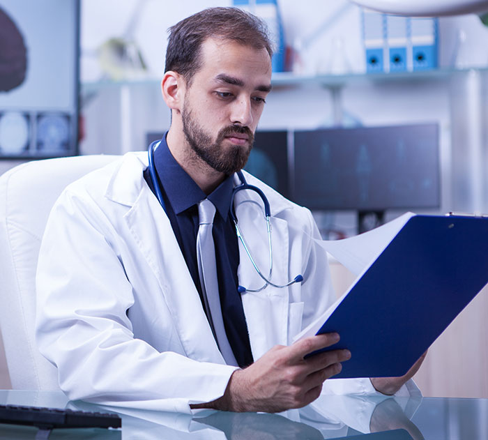 Doctor reviewing medical files, representing unusual incorrect diagnoses.
