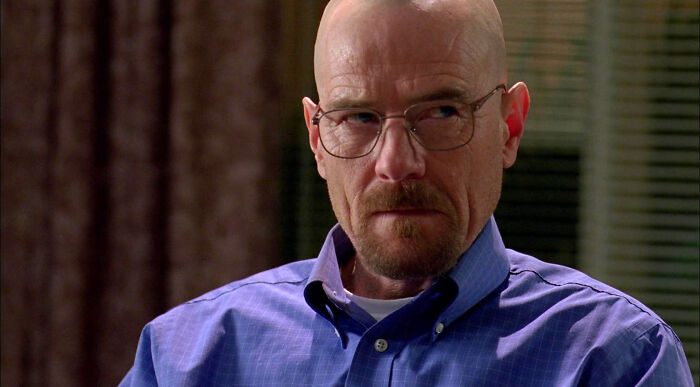 Man in glasses and blue shirt from a highly-rated TV show scene.