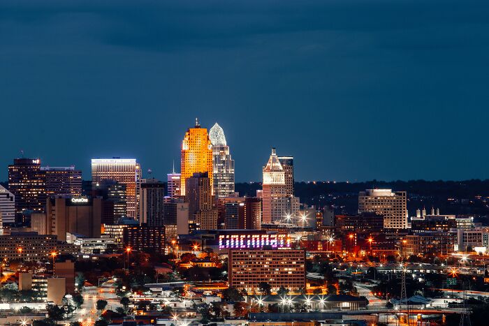 A vibrant city skyline, one of the best US travel destinations this summer, illuminated against the night sky.