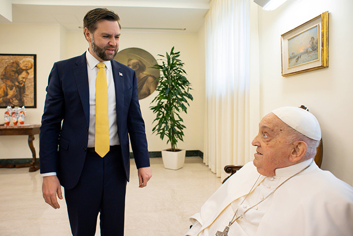 JD Vance meets with the Pope in a warmly lit room, engaging in a thoughtful conversation.