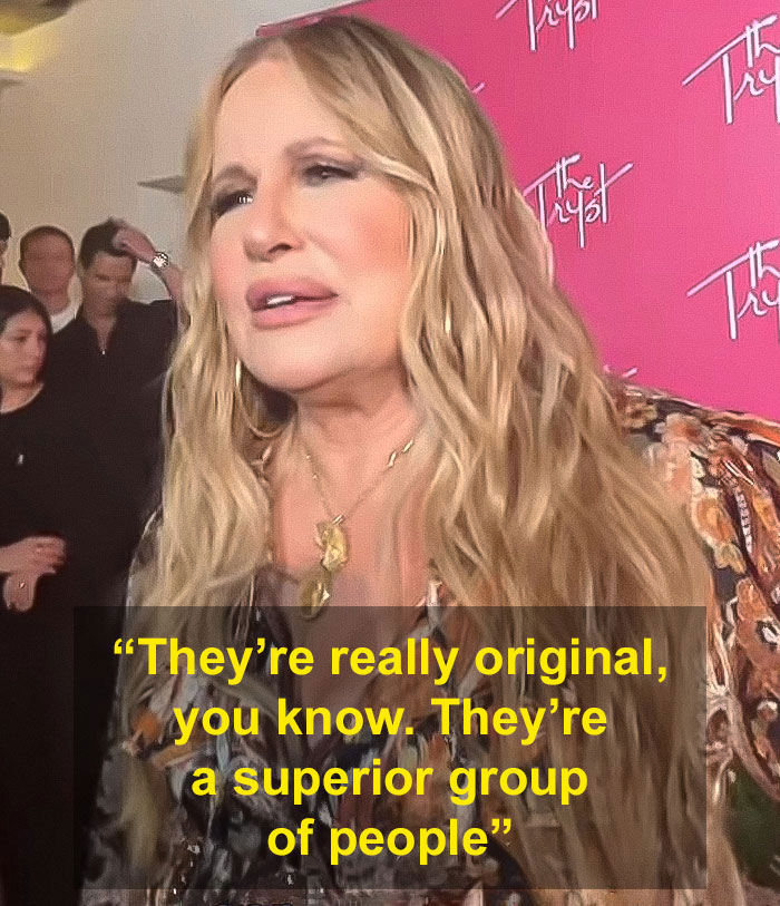 Jennifer Coolidge responds to a reporter's question about her LGBTQ+ fans at an event with a pink backdrop. Jennifer Coolidge responds to a reporter's question about her LGBTQ+ fans at an event with a pink backdrop.