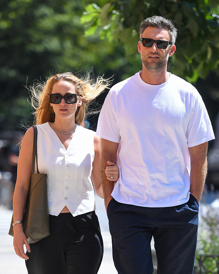 Couple walking outdoors, both wearing sunglasses. Main SEO keywords: Jennifer Lawrence, Cooke Maroney.