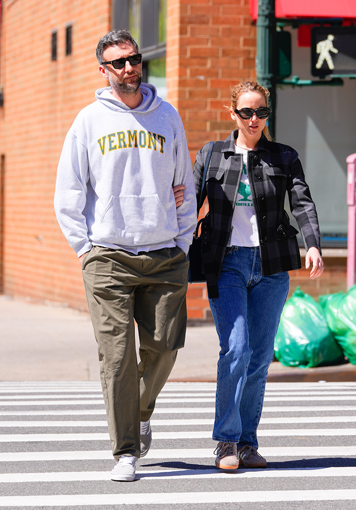 A couple walks arm in arm on a city street; main keywords: Jennifer Lawrence, Cooke Maroney.