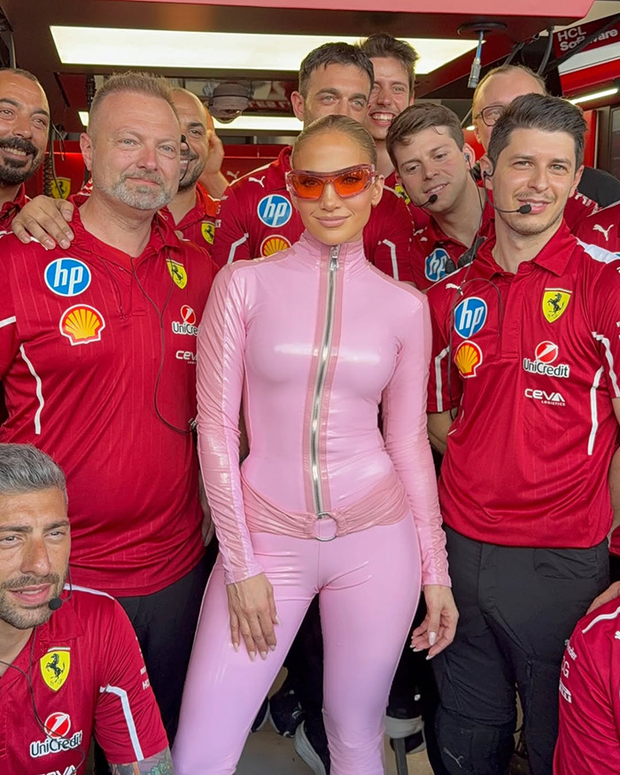 Person in pink catsuit with Ferrari team at the Saudi F1 race.