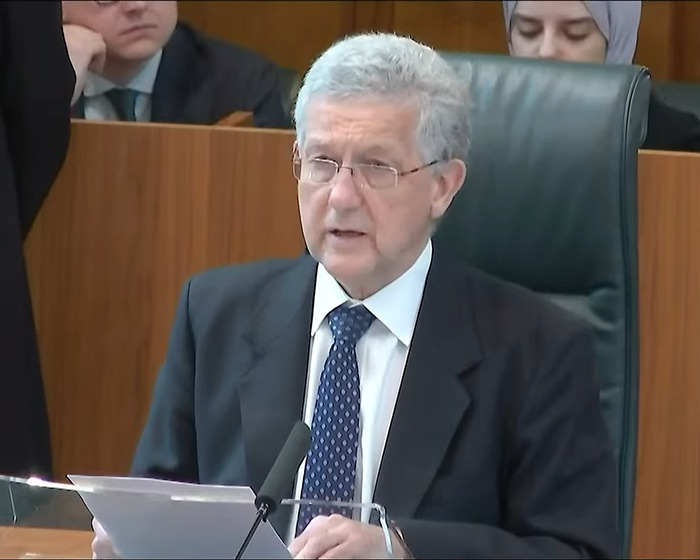 A person in a courtroom setting delivers a speech related to the Supreme Court's trans women decision.