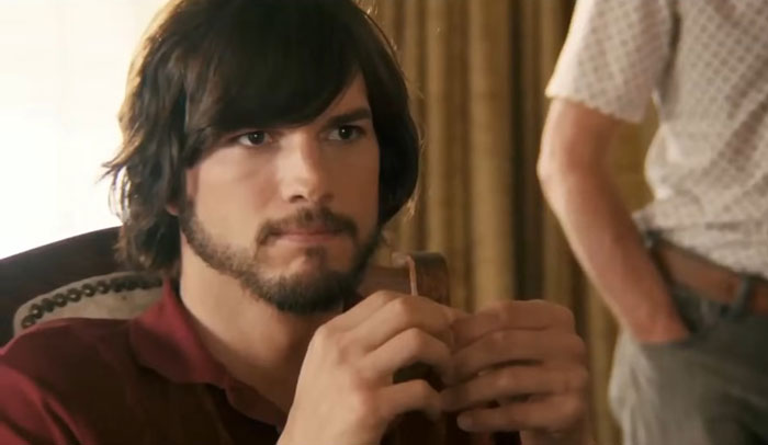 Actor portraying a challenging role with focused expression and holding an object, showcasing dedication above and beyond acting.