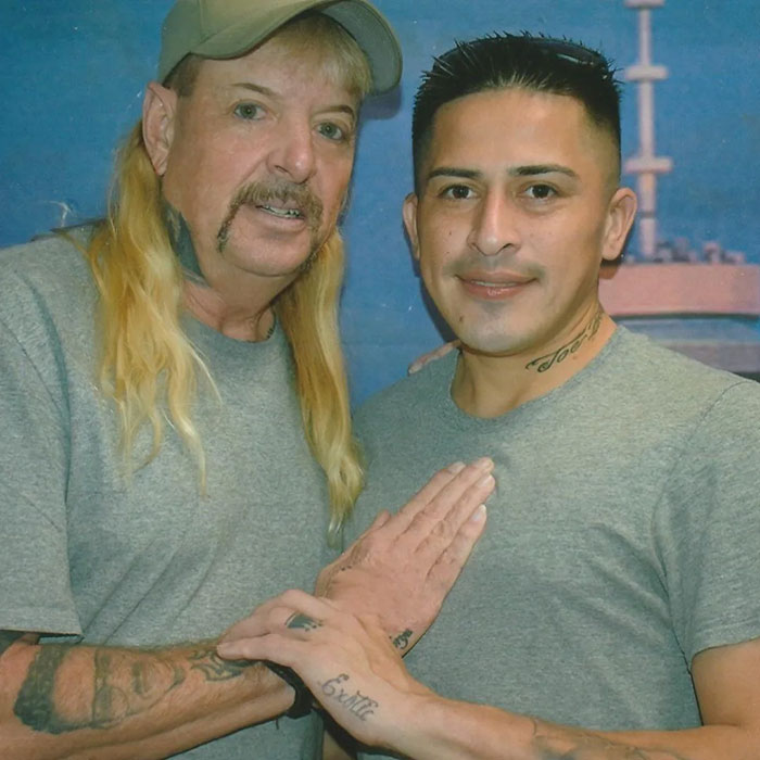 Two men in matching gray shirts posing together, related to Joe Exotic's 6th husband.